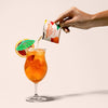 Craftmix Cocktail Packet - Blood orange mai tai - hand pouring orange packet into glass- Lockwood Shop - Craftmix