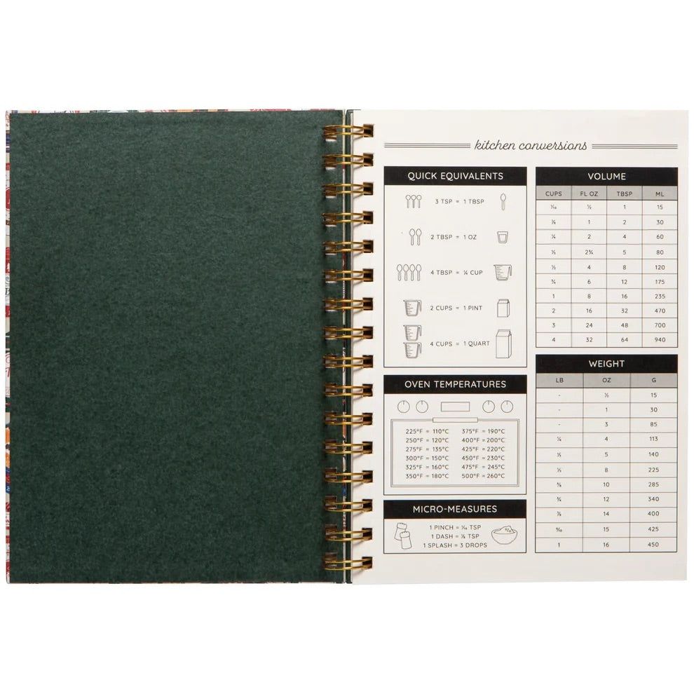 Open spiral-bound notebook with green cover and measurement conversion chart on white pages.