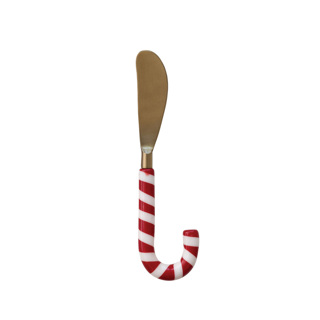 Butter knife with candy cane handle on a white background
