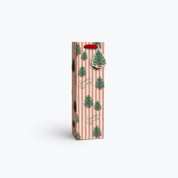 A tall, narrow gift bag or packaging sleeve with a festive Christmas pattern of green pine trees on a pink and white striped background, featuring a red hanging loop at the top, set against a plain white studio background.