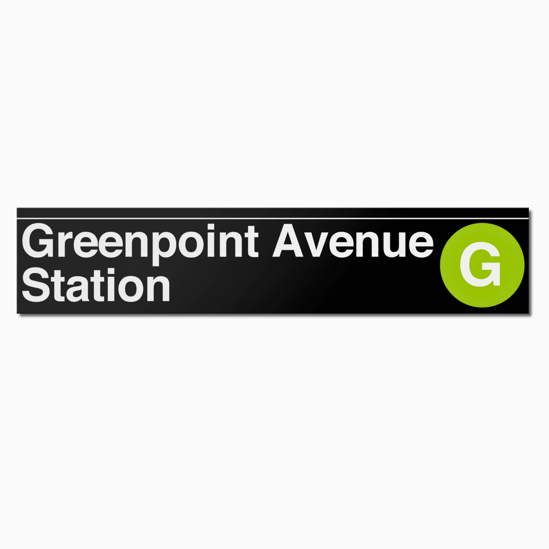 A rectangular black sign or sticker reading &