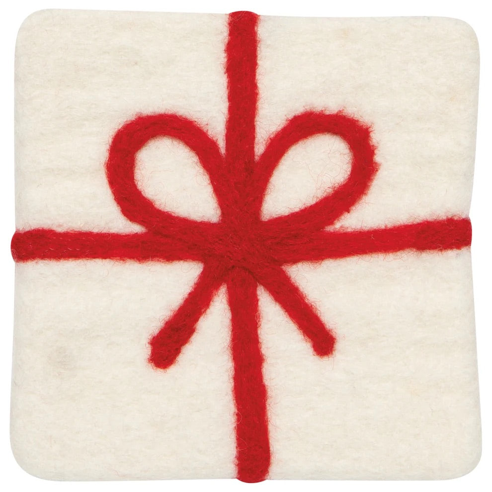 A square white felt cushion with rounded corners, decorated with a red felt gift-wrapped design featuring a bow and crosswise ribbon details.