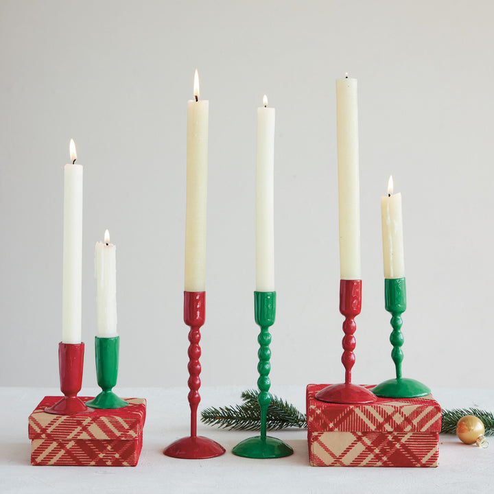 Set of six candles in red, green, and white candlesticks on a light gray background.