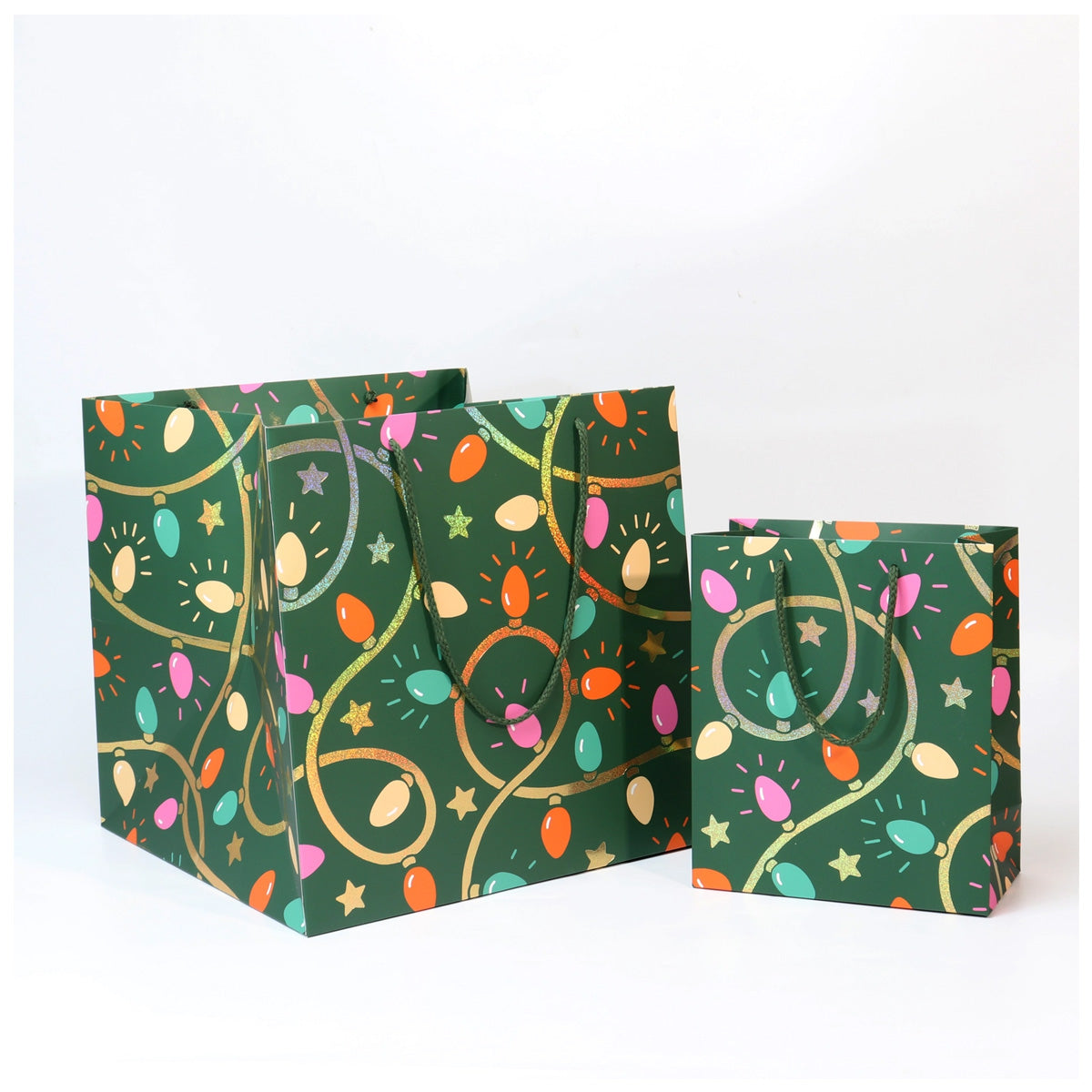 Three green gift bags with colorful festive pattern on a white background