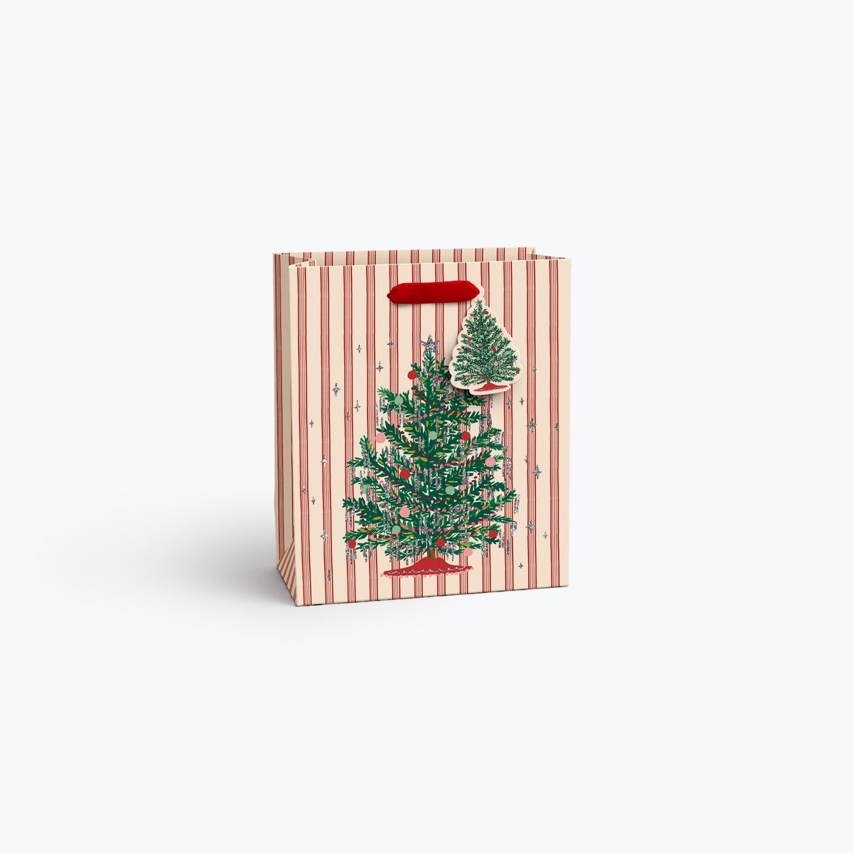 A small Christmas-themed gift bag with red and cream vertical stripes, featuring an illustration of a decorated green Christmas tree and a red handle, shown on a light gray background.