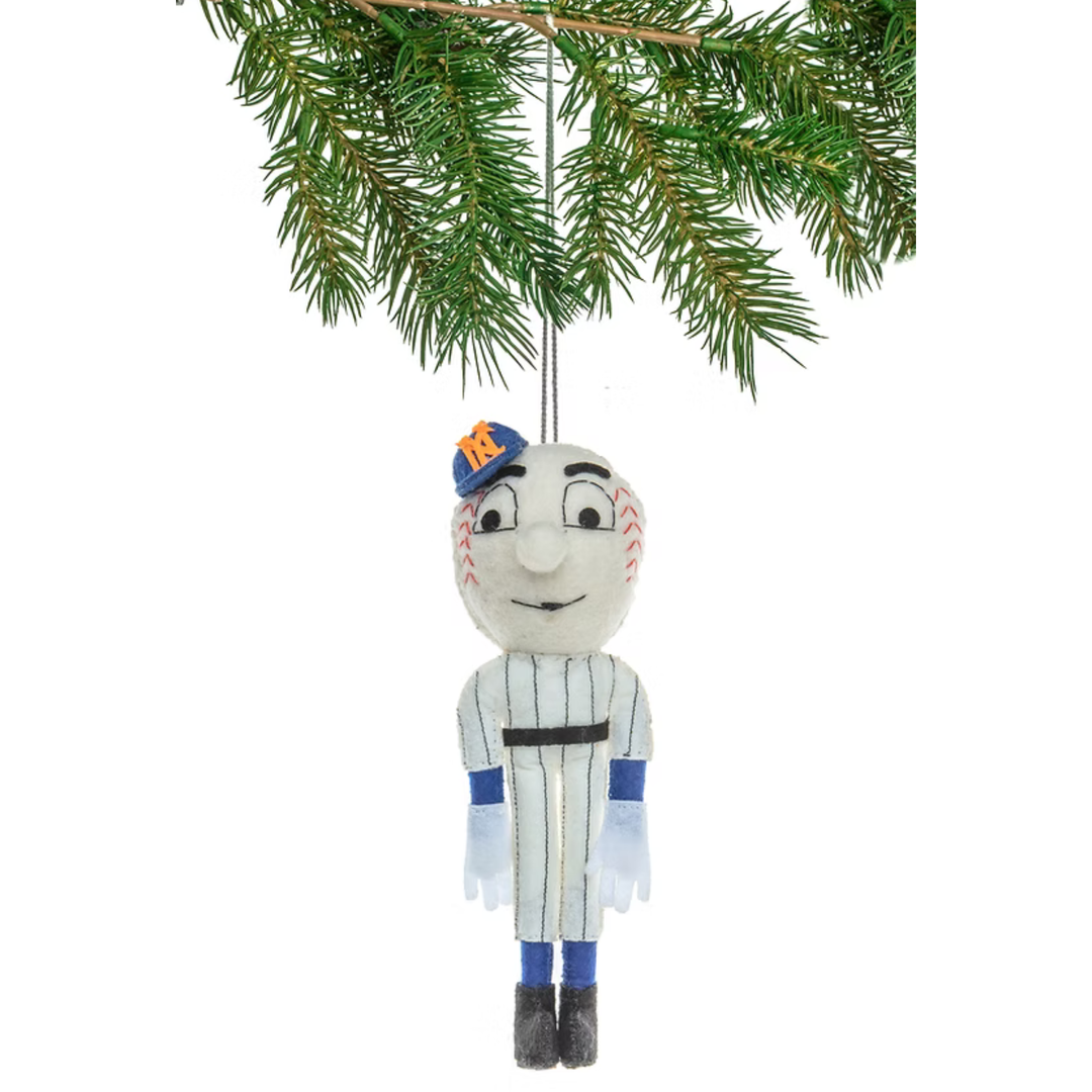 A hanging Christmas ornament shaped like a baseball player in a New York Yankees uniform, suspended from a pine branch against a white background.