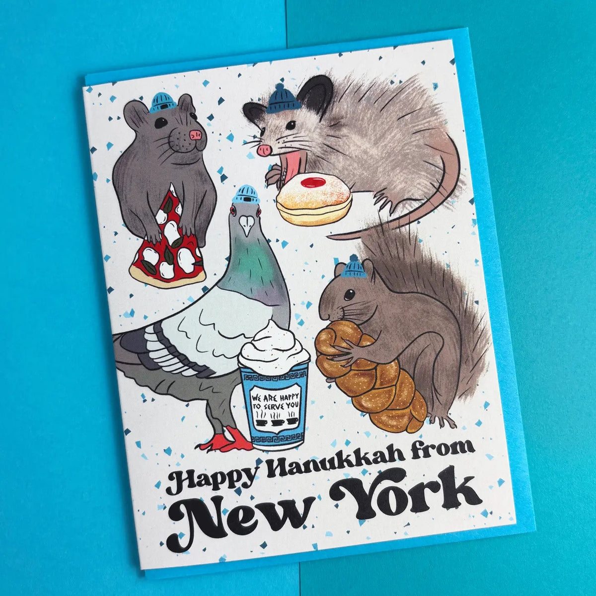 Card with illustrations of animals and text 'Happy Hanukkah from New York' on a blue background