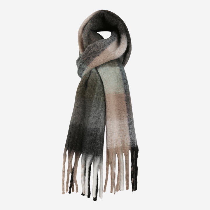 A soft, fuzzy scarf with a plaid pattern in shades of gray, beige, and light green, finished with fringed ends, shown on a plain light gray background.