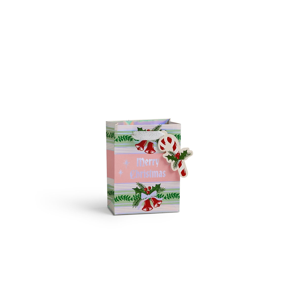 A small Christmas-themed gift bag with a pink front panel reading 'Merry Christmas,' striped pastel sides, green holly accents, and a hanging ornament shaped like a candy cane and cross, shown on a white background.