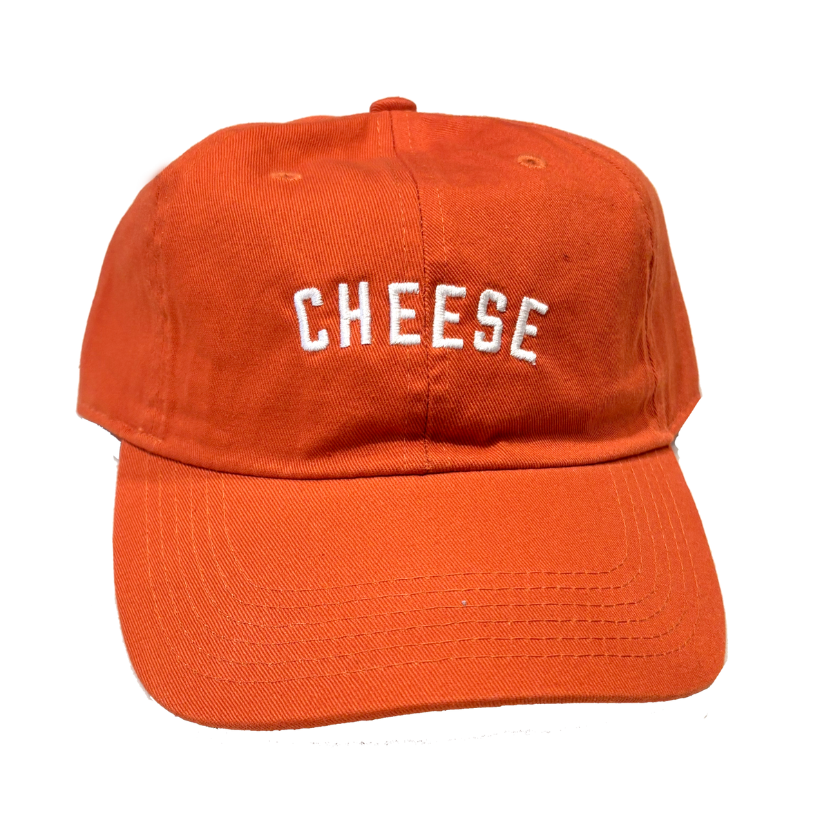 An orange cotton baseball cap with the word 'CHEESE' embroidered in white arched letters on the front, shown against a plain white background.