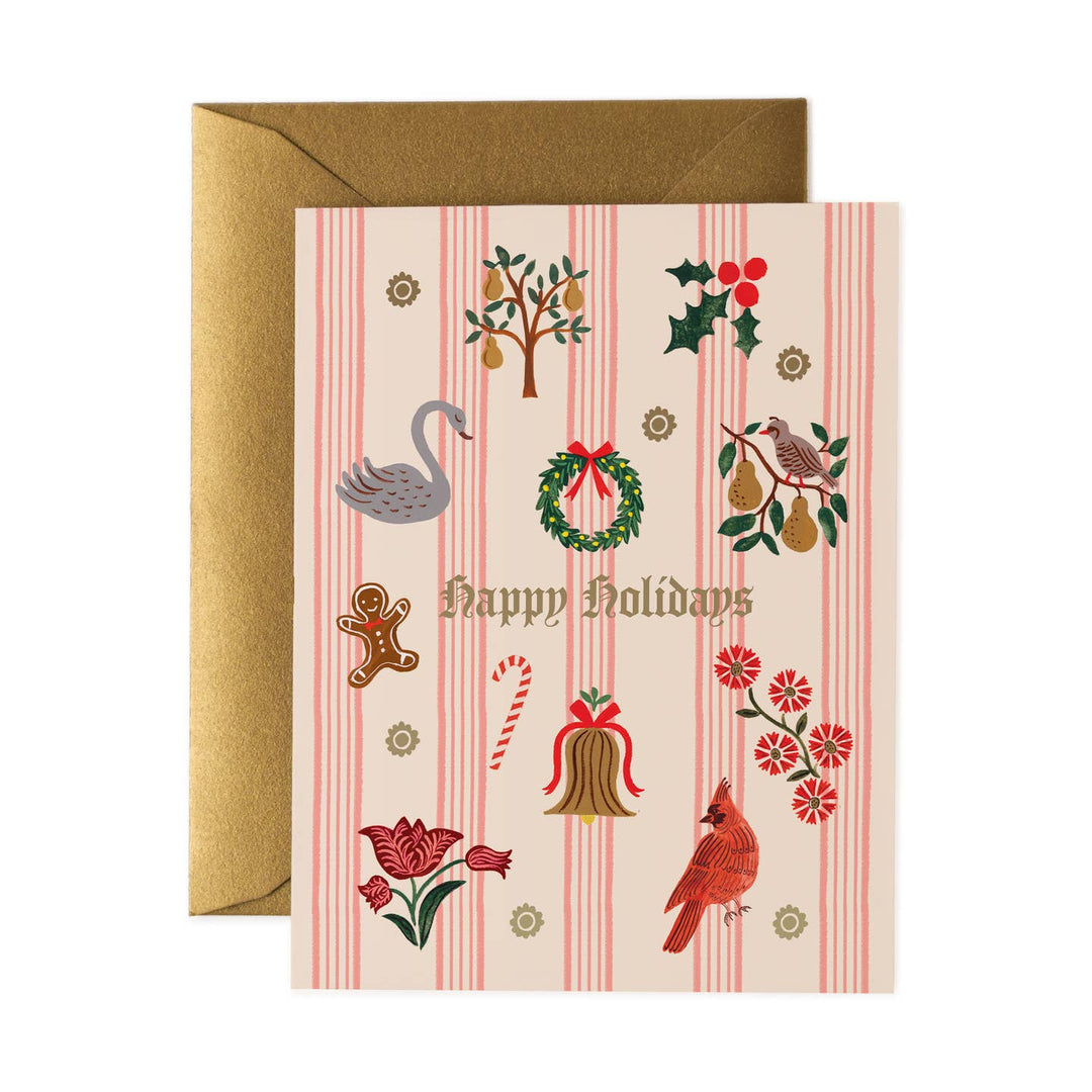 A Christmas greeting card with a gold envelope, featuring a cream background with pink vertical stripes and festive illustrations including a swan, wreath, candy cane, bell, flowers, and birds. The card reads &