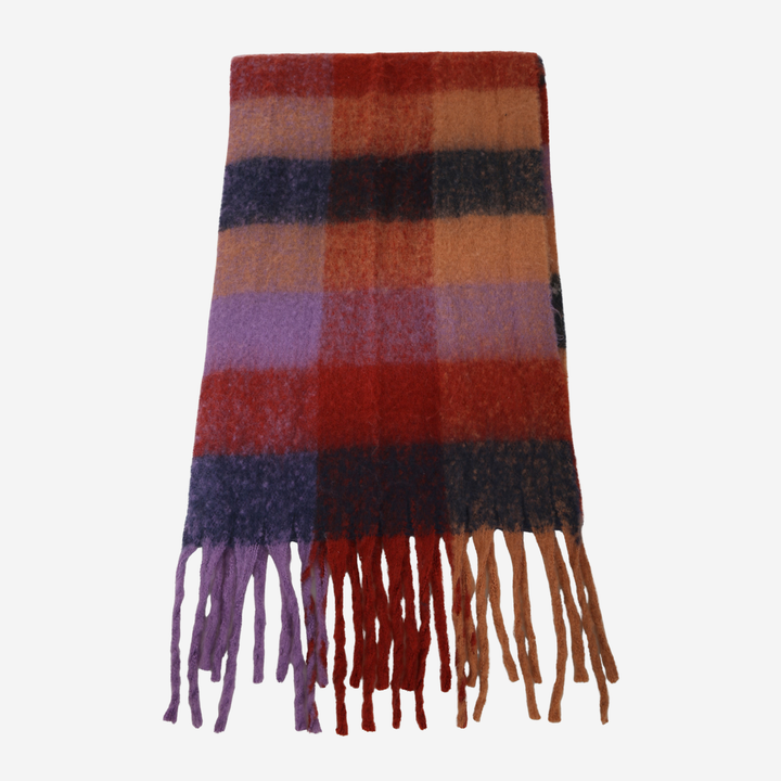 A folded plaid scarf with fringe tassels, featuring colors of rust red, orange, brown, purple, and black on a light gray background.