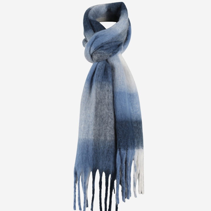 A lightweight knit scarf with a blue and white ombré ombre pattern and fringed ends, styled in a knot against a plain white background.