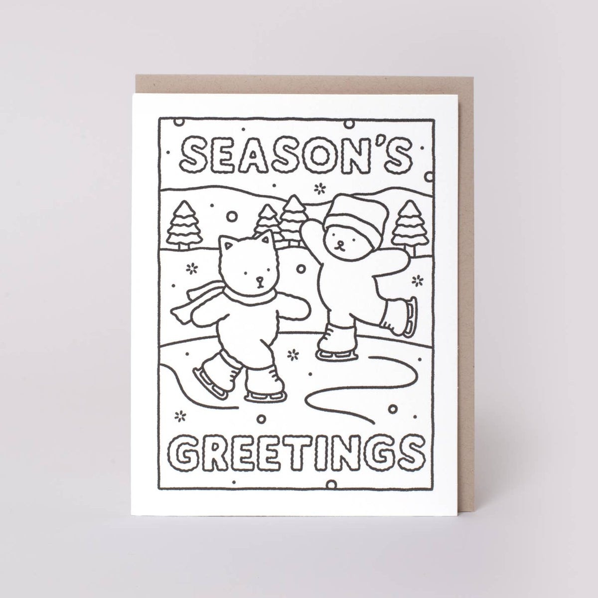 A black and white line art greeting card with a kraft envelope, featuring the text 'SEASON'S GREETINGS' and an illustration of a cat and a bear ice skating.