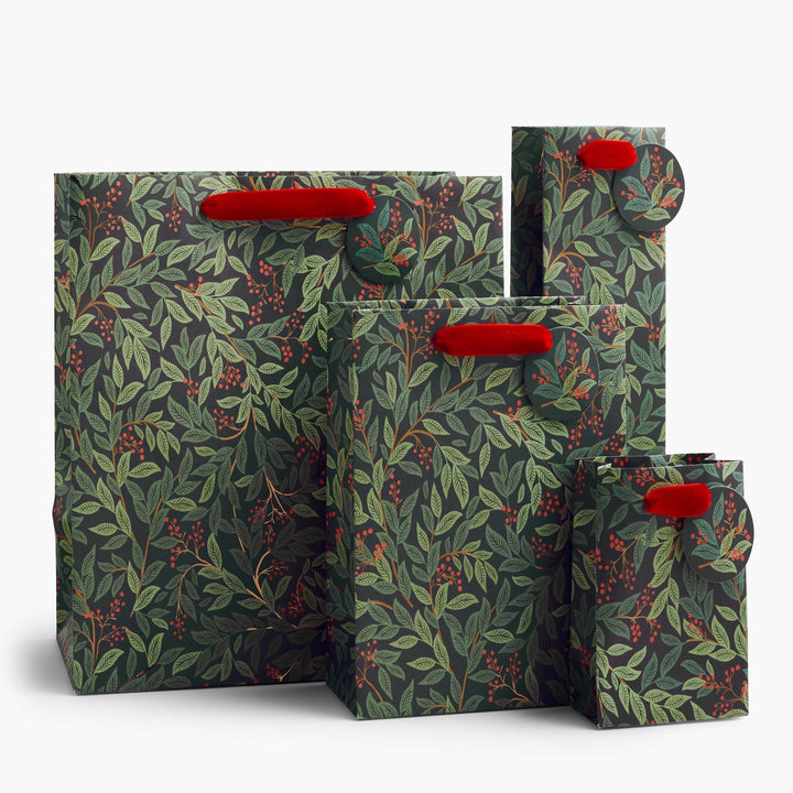 Four nested paper shopping bags with a dark green and gray botanical leaf pattern and bright red handles, shown on a clean white background.