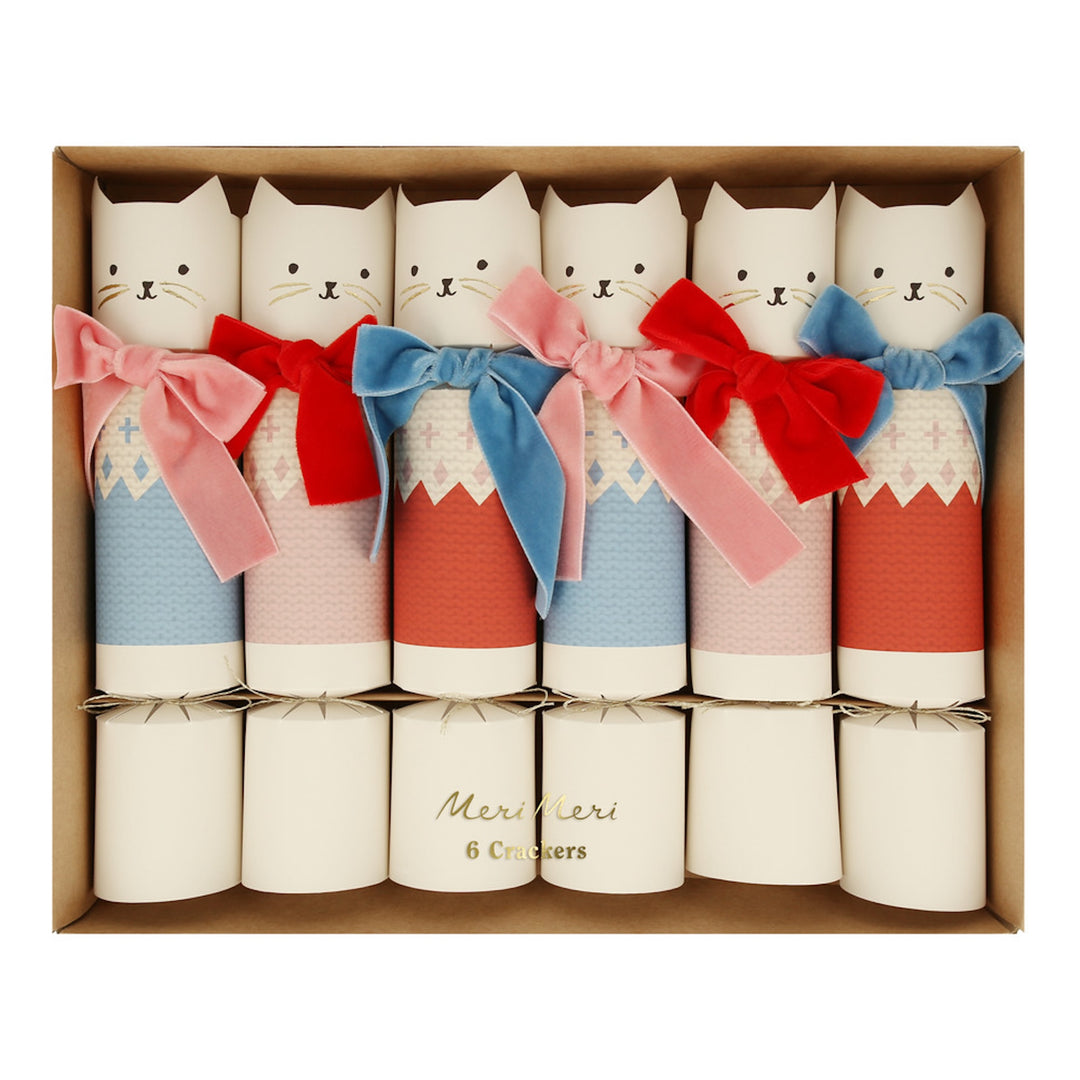 Set of decorative crackers with cat designs and colorful bows in a box.