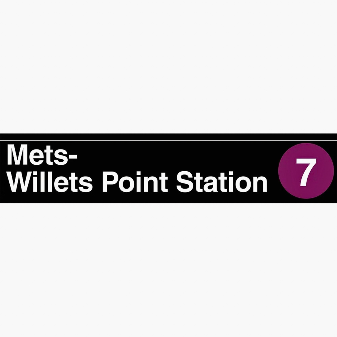 A rectangular black transit station sign reading &