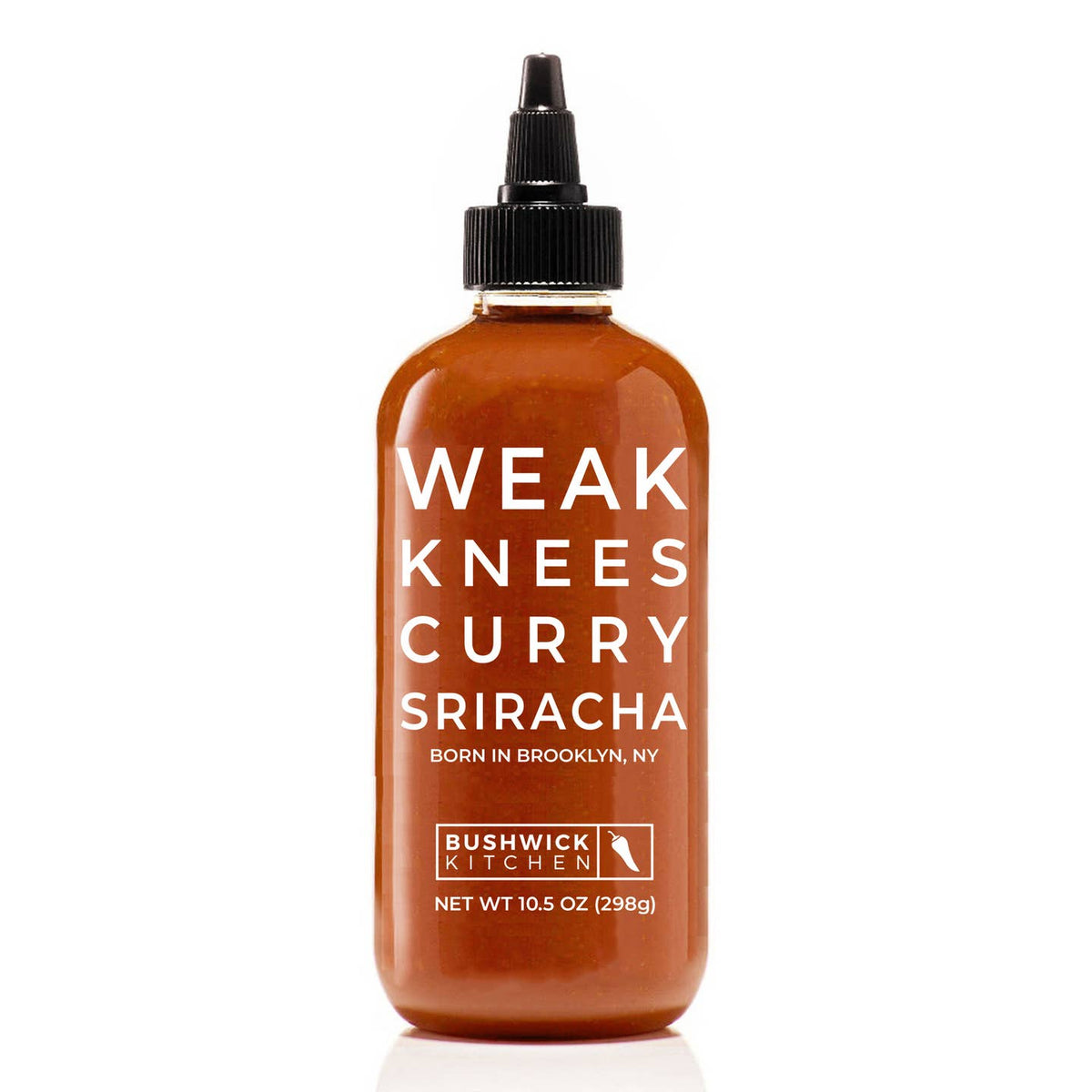 A bottle of Bushwick Kitchen Weak Knees Curry Sriracha sauce, featuring a translucent amber-brown bottle with white text and a black cap, set against a plain white background.