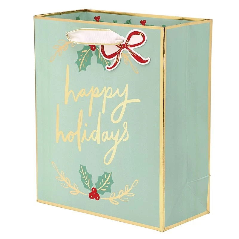 A mint green holiday gift bag with gold foil trim, featuring &