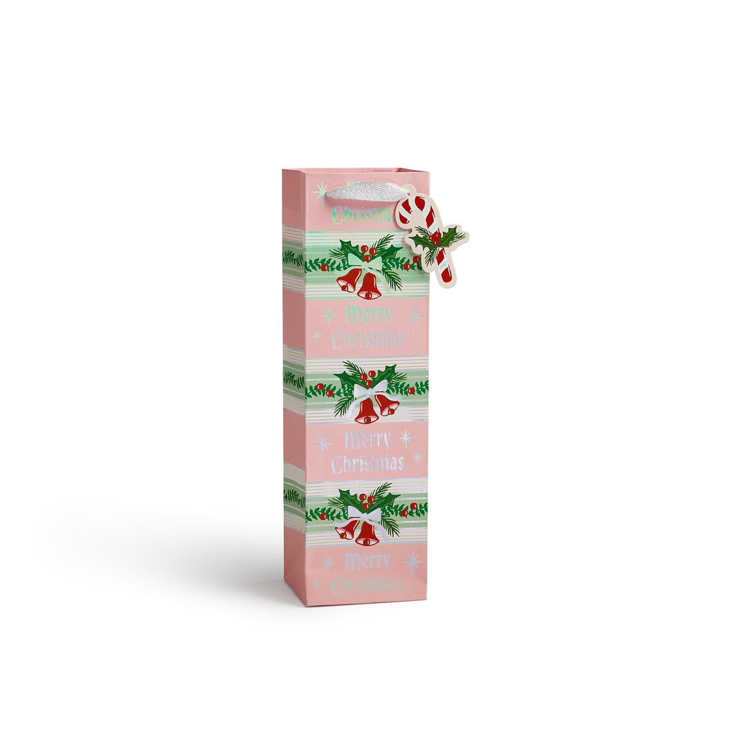 A tall, narrow pink gift bag or packaging box with festive Christmas illustrations, including green holly leaves, red bells, and candy canes, on a clean white background.