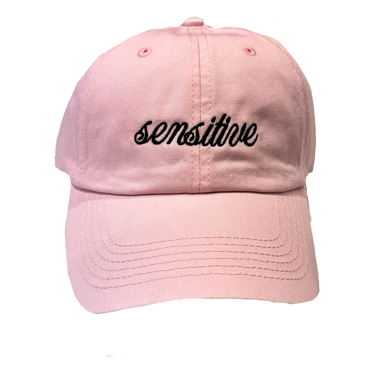 A light pink hat with black embroidered, script lettering that reads "sensitive."