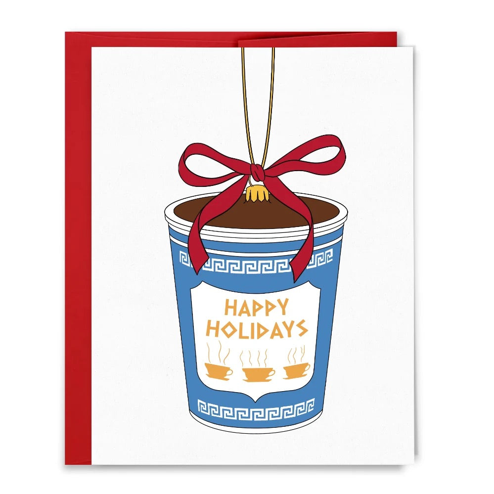 An illustration of a holiday greeting card featuring a classic blue and white New York City "Anthora" coffee cup reimagined as a hanging Christmas ornament.
The cup is tied with a festive red ribbon at the top, hanging from a golden string.