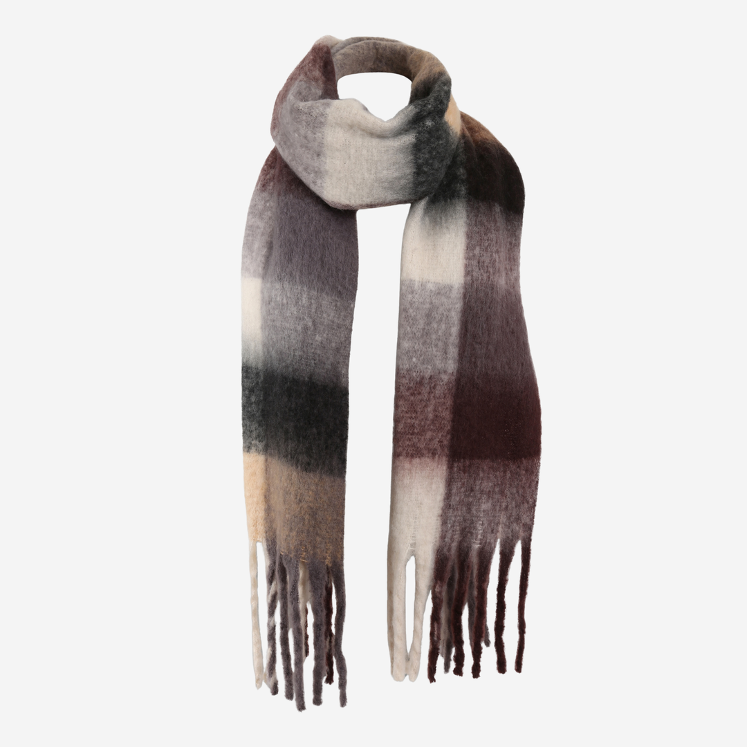 A soft, fuzzy scarf with a plaid pattern in shades of brown, beige, gray, and off-white, featuring fringed ends, shown on a plain light gray background.