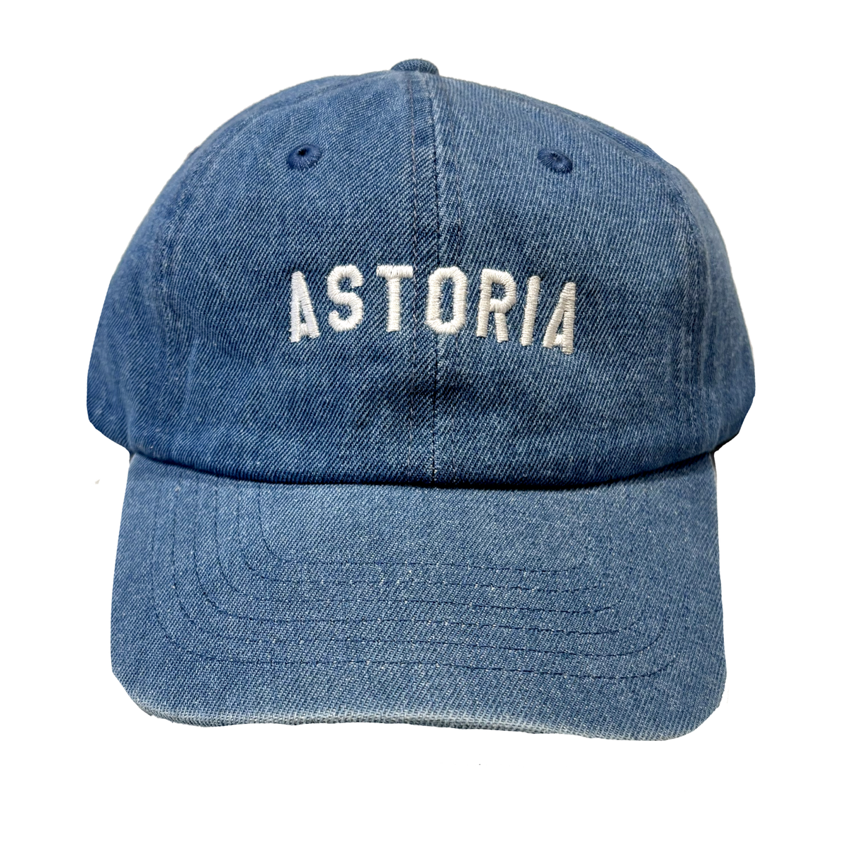 A denim hat with white embroidered lettering that reads "Astoria."