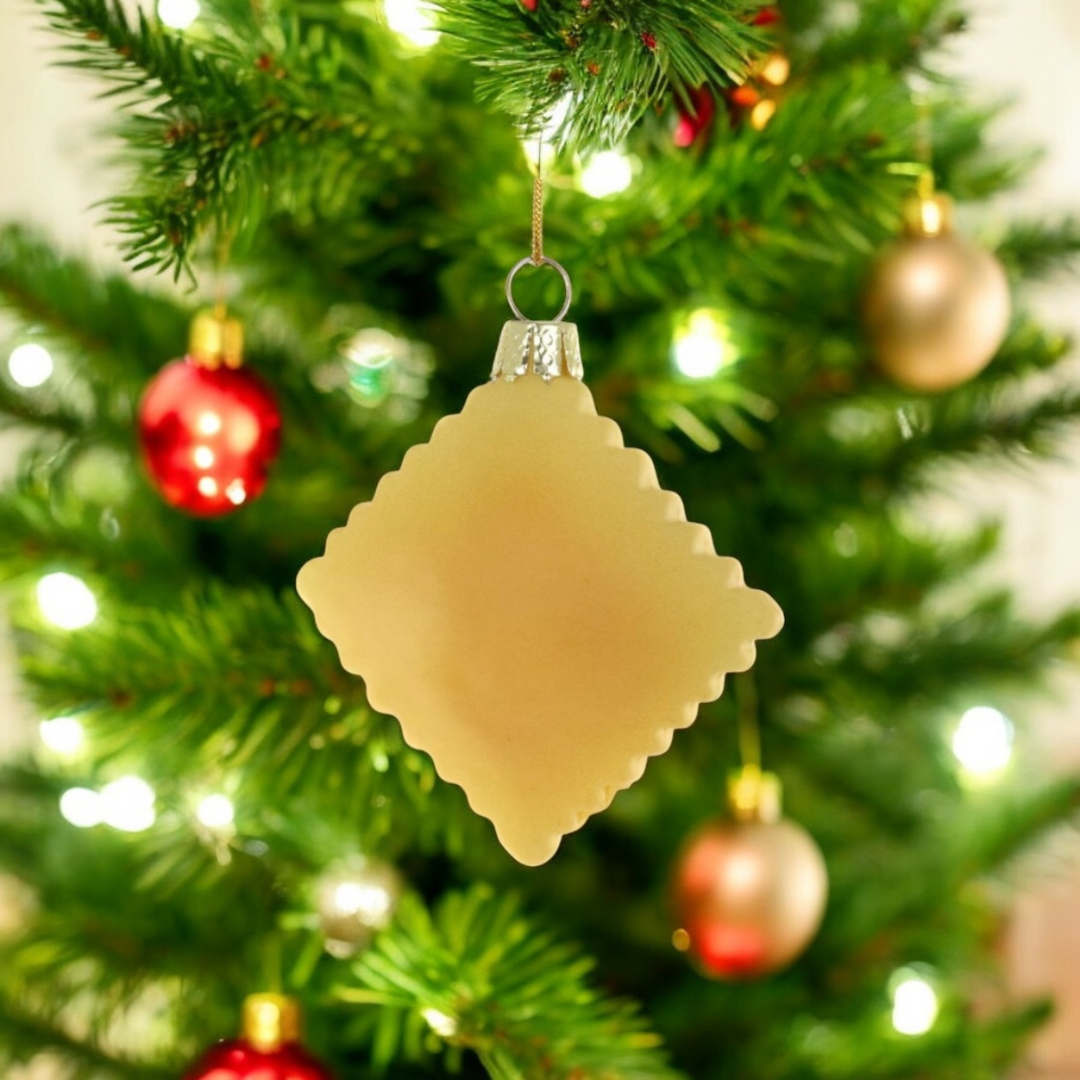 Decorative beige ornament on a Christmas tree with colorful ornaments and lights.