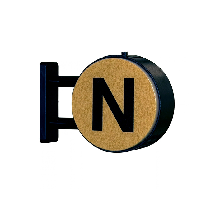 A circular wall sign with a black metal mounting bracket and a textured gold face featuring a large black letter N, shown against a plain white background.