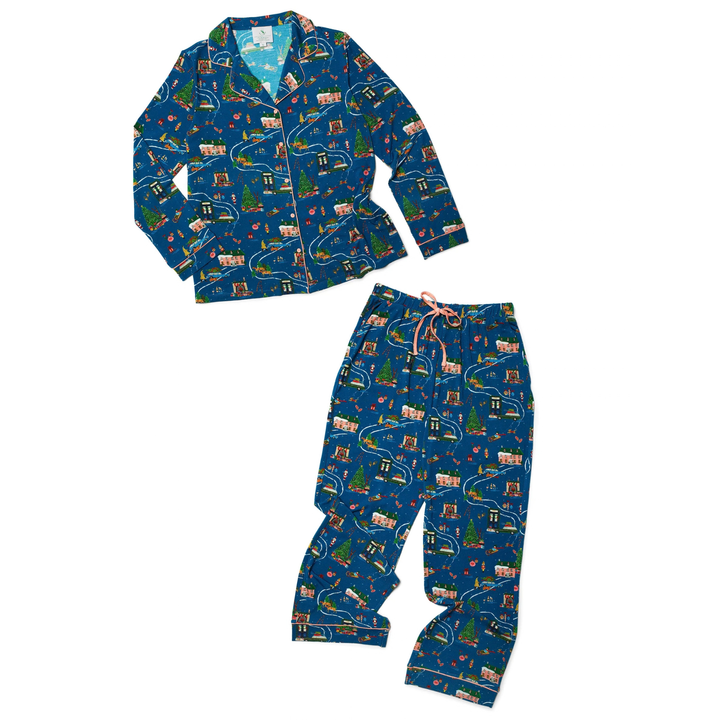 A two-piece pajama set featuring a long-sleeve top and matching pants in a dark blue holiday train print, displayed on a solid white background.