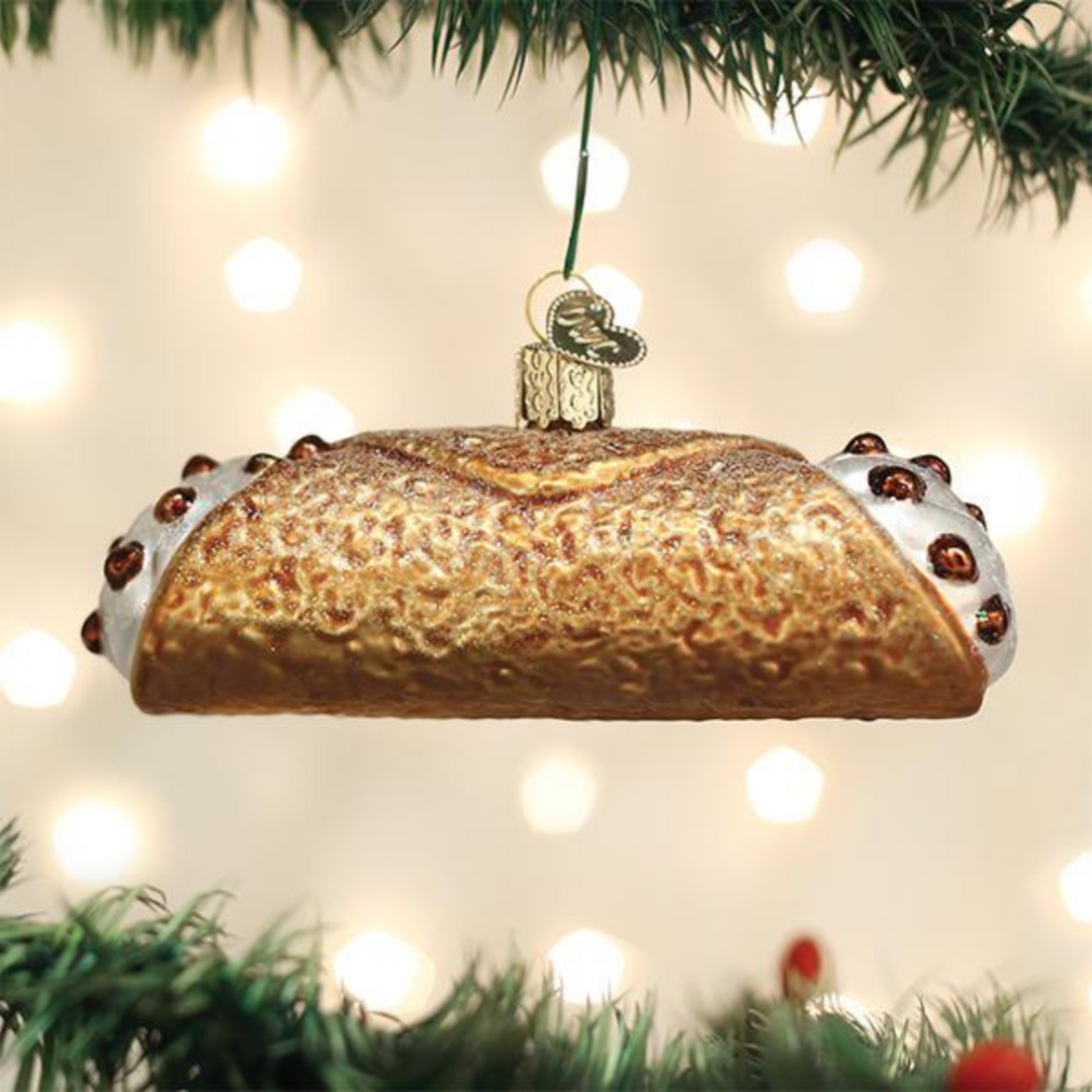Decorative bread ornament hanging on a Christmas tree with lights in the background