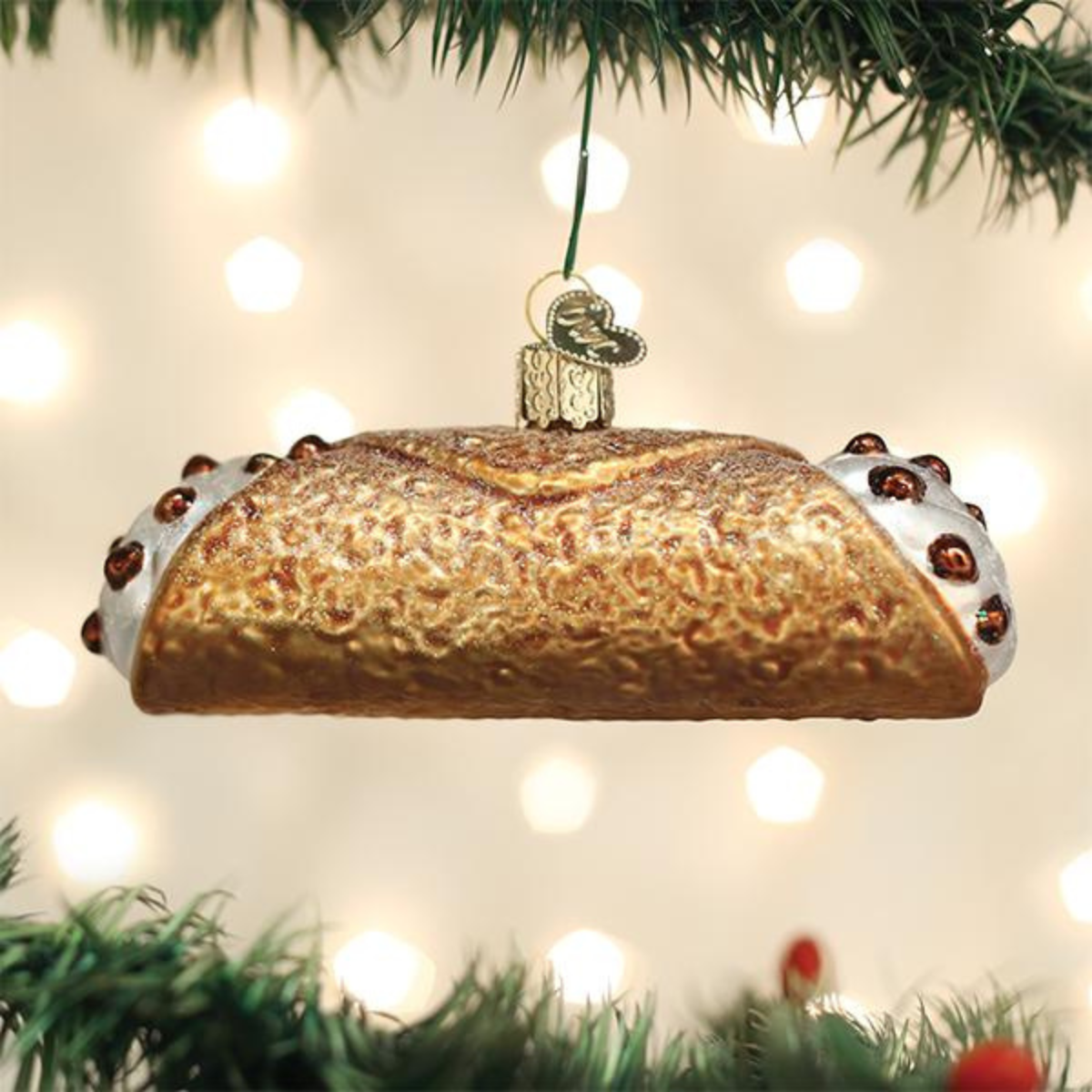 Decorative bread ornament hanging on a Christmas tree with lights in the background