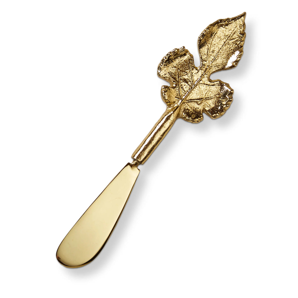 Gold butter knife with leaf design on a white background