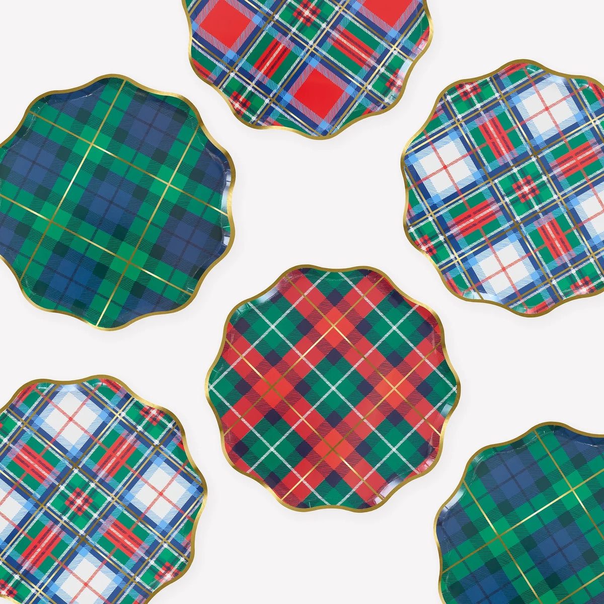 Six scalloped-edge ceramic plates with gold trim, arranged on a white background. Each plate features a different tartan plaid pattern in green, blue, red, and white.
