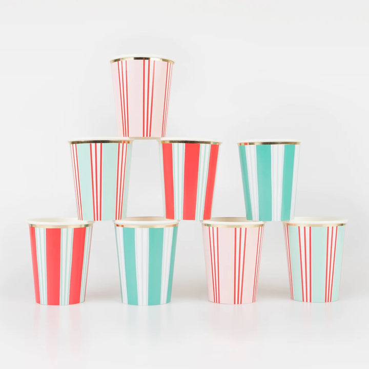 Seven paper cups with vertical stripes in red, mint green, and white, accented with gold rims, arranged in a pyramid stack on a white background.