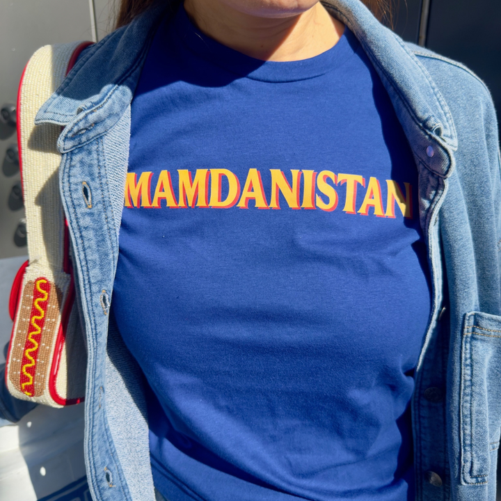 A person wearing a royal blue crewneck t-shirt with &