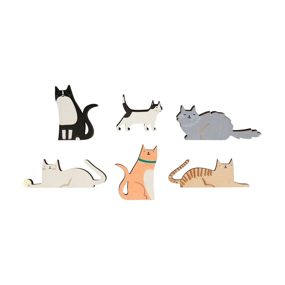 Set of cat-shaped wooden magnets on a white background