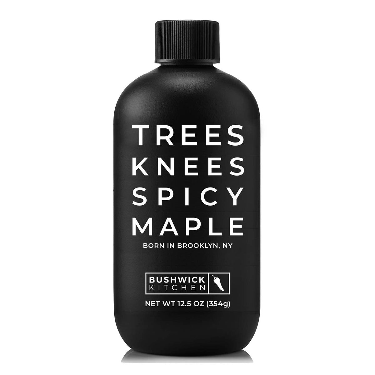 A matte black bottle of Bushwick Kitchen 'Trees Knees Spicy Maple' with bold white text, shown on a clean white background.
