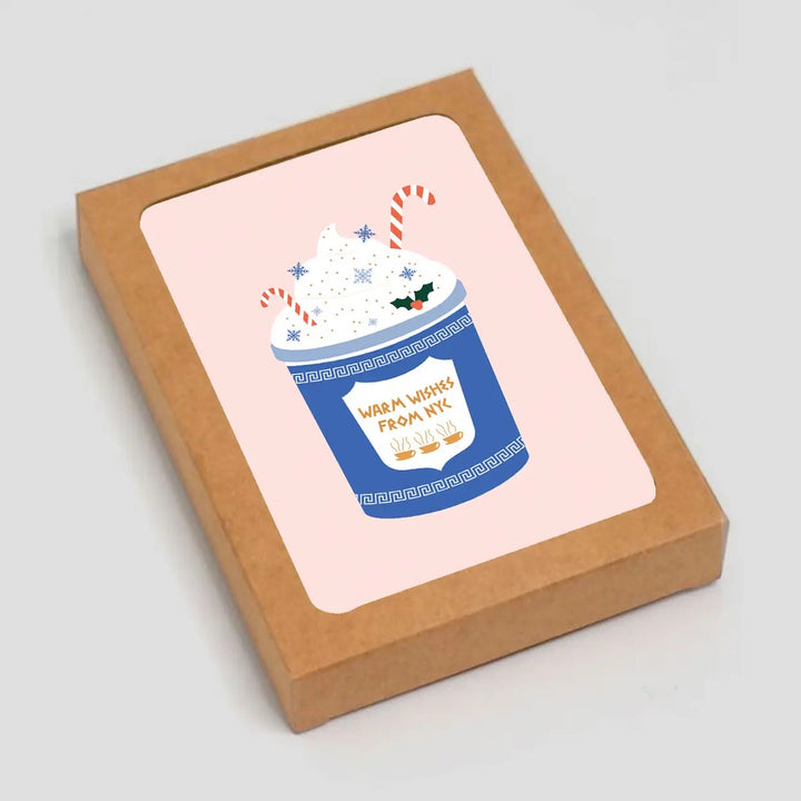 Card with a festive hot chocolate illustration in a brown box on a light gray background