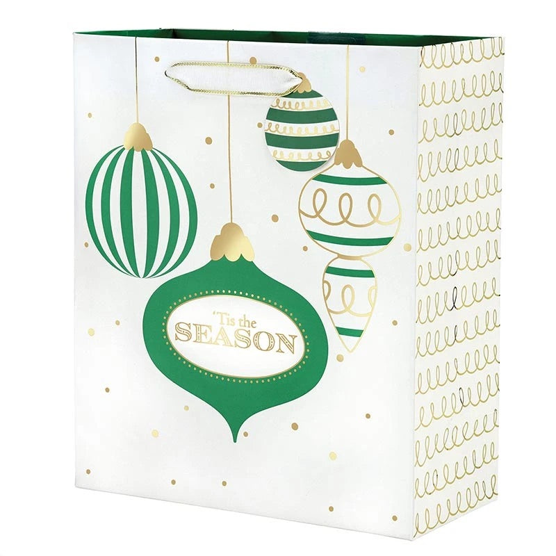 A white Christmas-themed gift bag with green and gold holiday ornament illustrations and the phrase 'It's the season' on the front, shown on a plain white background.