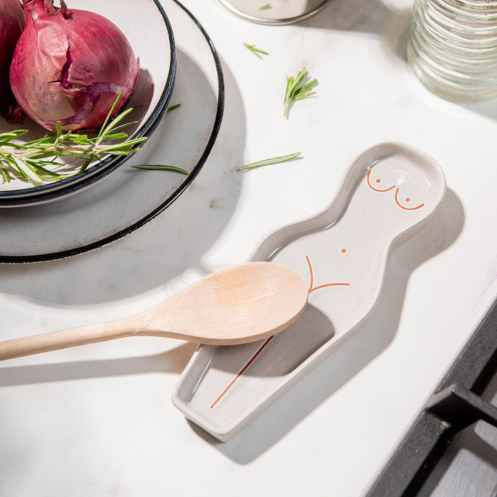 Spoon resting on body shaped spoon rest